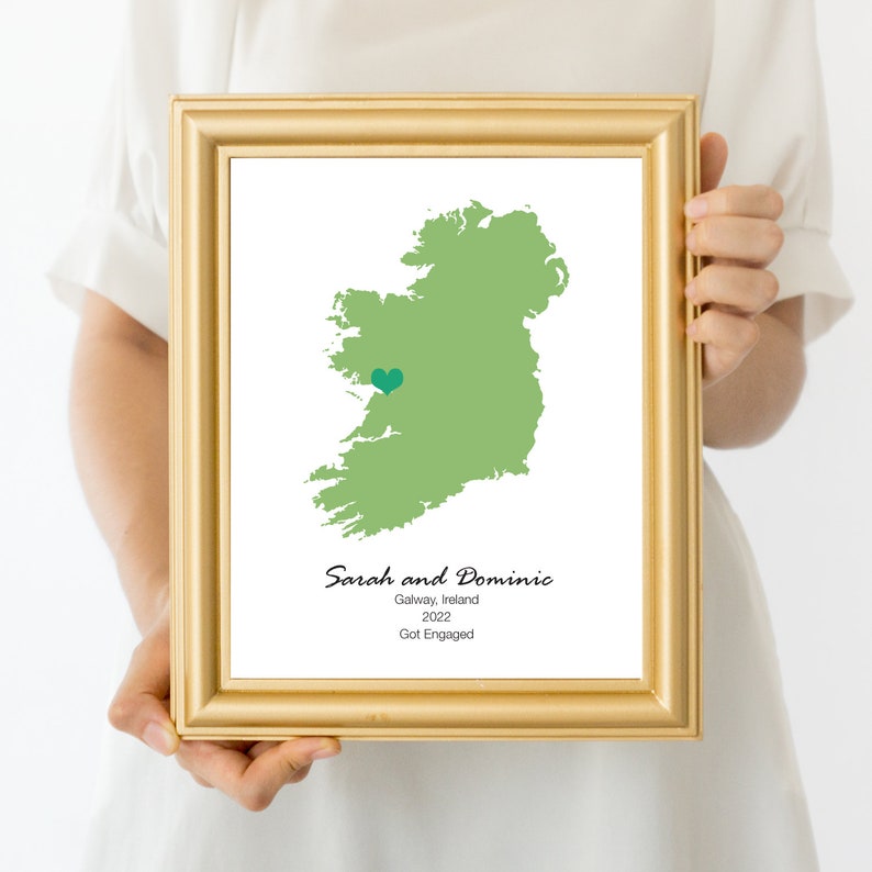 Person holding framed map with engagement location marked