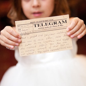 Girl holding a vintage style telegram guest book card at a wedding