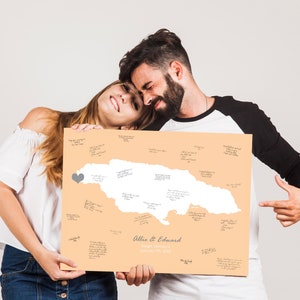 Couple with map of their wedding location that was signed by guests, gift idea for destination wedding