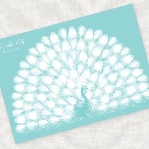 May include: A teal-colored card featuring a white peacock design. The peacock's tail feathers are spread out, and the bird is facing to the right. The text "Serity and Andy" and "28th April 2011" are written in a script font at the top left.