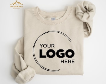 May include: A beige sweatshirt with a black circle and the text "YOUR LOGO HERE" printed on the front.
