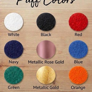 a collection of nine different colored puffy felt materials, including white, black, red, navy blue, metallic rose gold, blue, green, metallic gold, and orange.