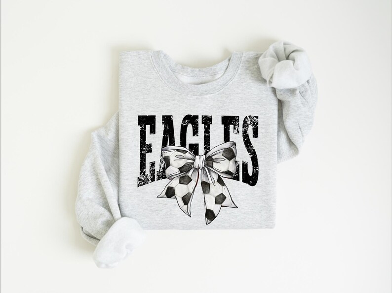 A gray sweatshirt with the word "EAGLES" and a bow printed on it.