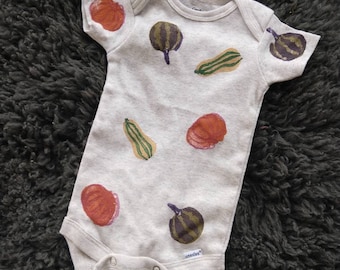 Hand dyed block printed fall squash and gourd onesie in oatmeal