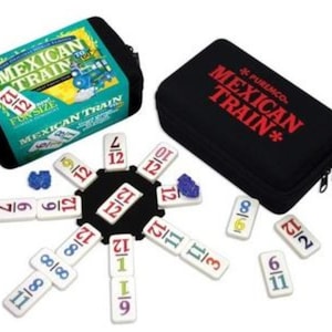 May include: A black carrying case with the text "MEXICAN TRAIN*" printed in red. The case is open to reveal a set of dominoes with numbers and fractions. The dominoes are arranged in a circle around a black center piece.