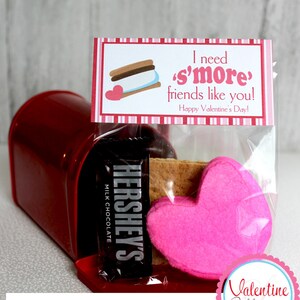 May include: A red mailbox holds a clear cellophane bag with a Hershey's milk chocolate bar, a graham cracker, and a pink felt heart. The bag has a tag that reads "I need s'more friends like you! Happy Valentine's Day!"