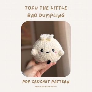 May include: A crocheted white dumpling with a smiling face and small pink cheeks. The dumpling is held in a hand. Text at the top reads "TOFU THE LITTLE BAO DUMPLING". Below the dumpling, the text reads "PDF CROCHET PATTERN".