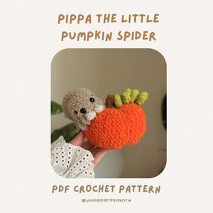 May include: A crochet plush toy featuring a light brown spider with black eyes emerging from a bright orange pumpkin with a brown stem and green leaves. The text PIPPA THE LITTLE PUMPKIN SPIDER and PDF CROCHET PATTERN is displayed above and below.