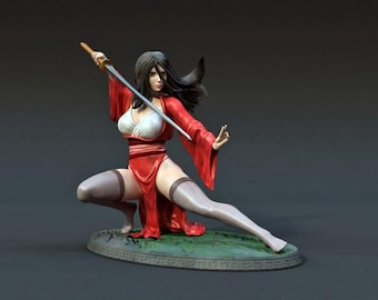 May include: A figurine of a woman in a red and white outfit holding a sword. She is in a fighting pose with one leg forward and the other bent. The figurine is on a green base with a brown rim.