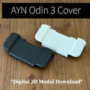 May include: A black and a white AYN Odin 3 cover, presented as a digital 3D model download. The rectangular covers feature contoured side grips and a central flat panel, designed to protect the handheld gaming console screen and controls.