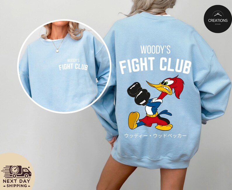 a woman wearing a blue woody's fight club sweatshirt