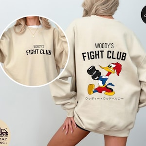 a woman wearing a sweatshirt with a cartoon character on it