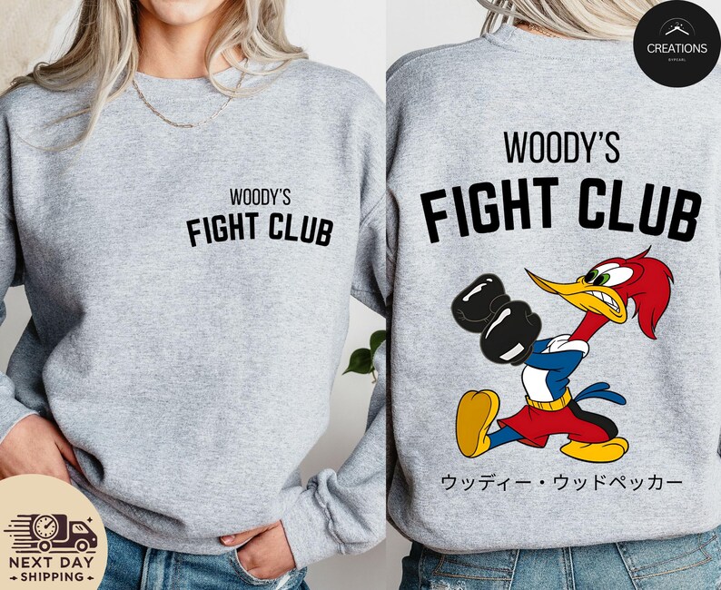 a woman wearing a woody's fight club sweatshirt
