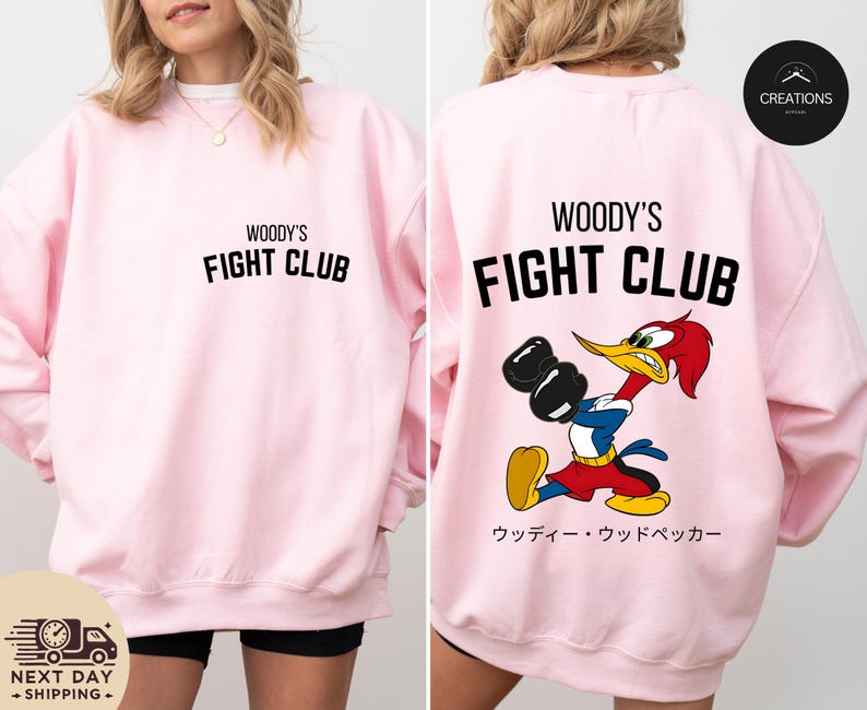 a woman wearing a pink woody's fight club sweatshirt