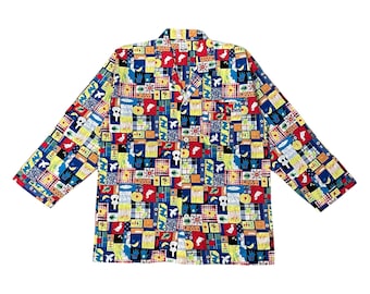 May include: A long-sleeved button-down shirt with a colorful patchwork pattern. The design features various shapes and illustrations in red, blue, yellow, and green. The shirt has a collar and a chest pocket.