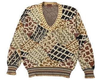 May include: A vintage V-neck sweater with a geometric pattern in shades of brown, beige, black, and tan. The sweater features ribbed cuffs and hem, and a decorative trim around the neckline.