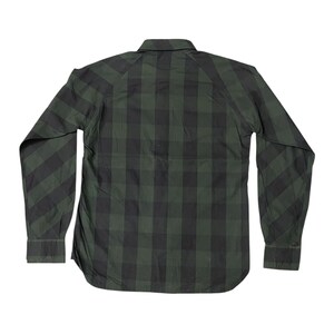 May include: A long-sleeved, button-down shirt in a green and black plaid pattern. The shirt has a classic collar, buttoned cuffs, and a curved hemline. The back of the shirt is visible, showcasing the plaid design.