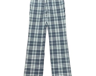 May include: Full-length trousers featuring a classic plaid pattern in shades of black, white, and grey. The pants have a structured waistband with belt loops, a front zipper fly, and a straight-leg cut, showcasing a consistent grid design.