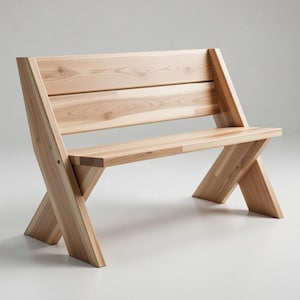 Könnte beinhalten: Helle Holzbank mit Lattenrücken und Sitzfläche. Die Bank hat eine abgewinkelte Rückenlehne und gekreuzte Beine, die ein modernes Design zeigen. Die Holzmaserung ist sichtbar und trägt zu ihrer natürlichen Ästhetik bei.