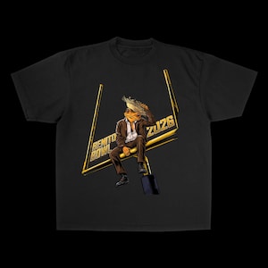 May include: Black t-shirt featuring a cartoon frog wearing a suit and sitting on a golden goalpost. The goalpost has the text "BENITO BOWL" and "ZU26". The frog is wearing a suit and has a feather in its hair.