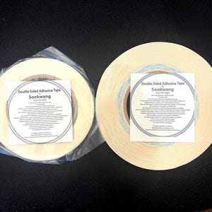 May include: Two rolls of off-white double-sided adhesive tape by Sookwang. One roll is wrapped in clear plastic. Each roll features a square white label with black text detailing product specifications, including heat resistance and usage.