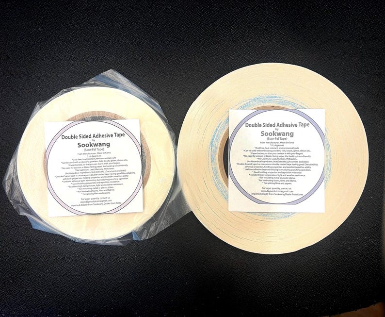 May include: Two rolls of off-white double-sided adhesive tape by Sookwang. One roll is wrapped in clear plastic. Each roll features a square white label with black text detailing product specifications, including heat resistance and usage.