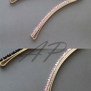 May include: Two gold-toned hair barrettes. One is adorned with black beads, the other with pink beads. The barrettes have a curved design, and the beads are evenly spaced along the top. These hair accessories are suitable for various hairstyles.