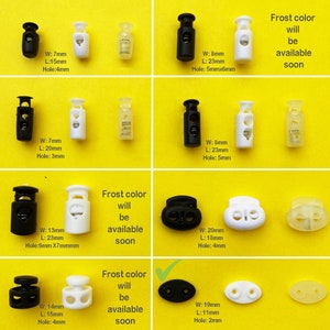 May include: Assortment of black and white plastic cord locks with different sizes and hole dimensions. The text "Frost color will be available soon" is displayed on the image.