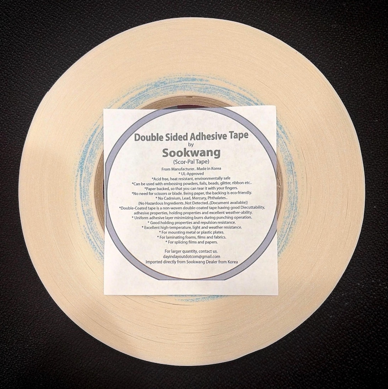 May include: A roll of beige double-sided adhesive tape by Sookwang, also known as Scor-Pal Tape. A square white label is centered on the roll, featuring black text detailing product specifications, safety certifications, and usage instructions.