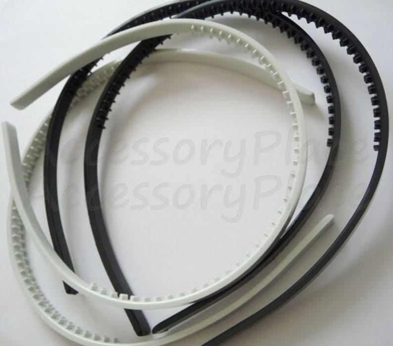 May include: A set of four plastic headbands, two black and two white. The headbands have a textured, ridged surface for grip.