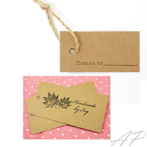 May include: Two brown kraft paper gift tags with twine string. One tag has the text "Thanks to" with a line underneath. The other tag has a black maple leaf design and the text "Handmade by Ivy".