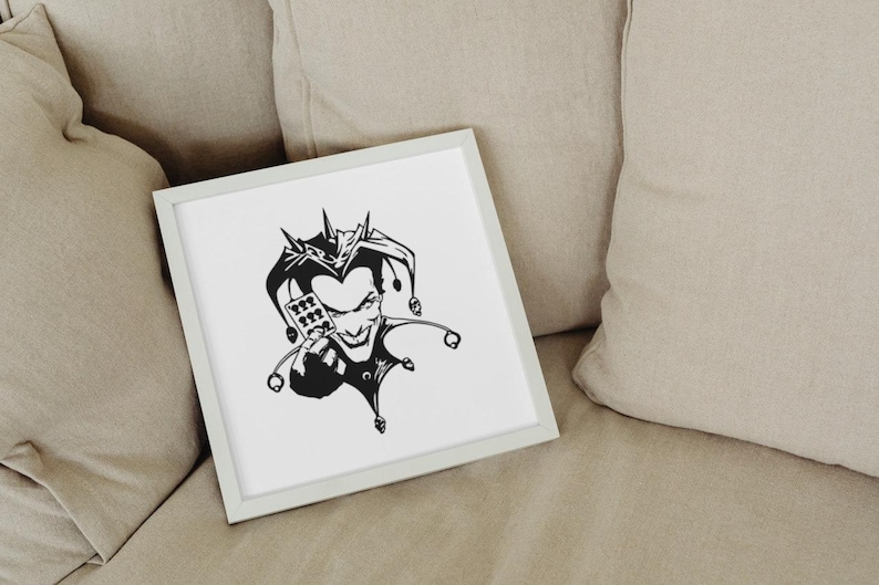 May include: A framed black and white illustration of a jester with a sinister grin. The jester is holding a device with playing card symbols. The artwork is displayed on a white background within a light gray frame.