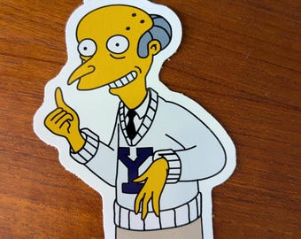 May include: A yellow cartoon character with a white sweater and a blue "Y" on the front. The character is smiling and pointing with one finger.