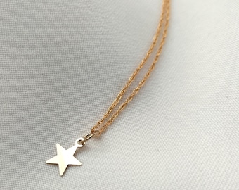 Tiny gold star pendant