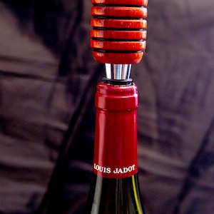 Handmade wooden wine bottle stoppers hand turned from exotic wood with stainless steel.