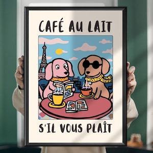 May include: Framed art print featuring two cartoon dachshunds at a cafe in Paris. One dog reads a newspaper, the other wears sunglasses and a scarf. The Eiffel Tower and the words "CAFÉ AU LAIT" and "S'IL VOUS PLAÎT" are visible.