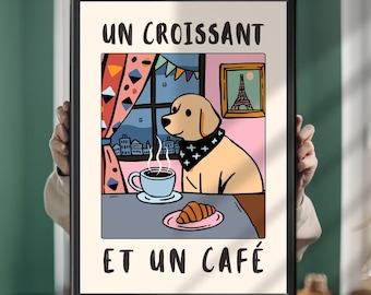 May include: A framed rectangular wall art print featuring a light-coloured dog wearing a black bandana, sitting at a table with a steaming cup of coffee and a croissant. The text UN CROISSANT ET UN CAFÉ is printed in black at the top and bottom.