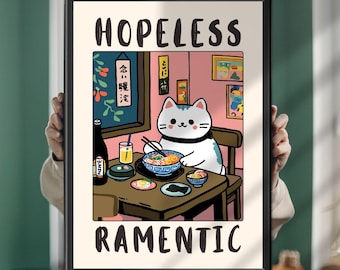 May include: A framed art print featuring a white cat sitting at a table eating ramen with chopsticks. The text "HOPELESS" appears at the top and "RAMENTIC" at the bottom. The illustration includes a bottle, a glass, and small bowls on a table in a pink room.