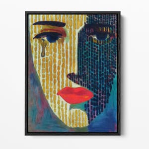 May include: A framed painting depicting a stylised face split into two distinct halves. The left side features yellow vertical dashes with a single blue eye and a teardrop. The right side is composed of dark blue and black textured marks.