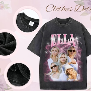 May include: Dark gray t-shirt with the name "ELLA" in pink, featuring a portrait of a woman. The shirt has a vintage, distressed look. The words "Clothes Details" are at the top.