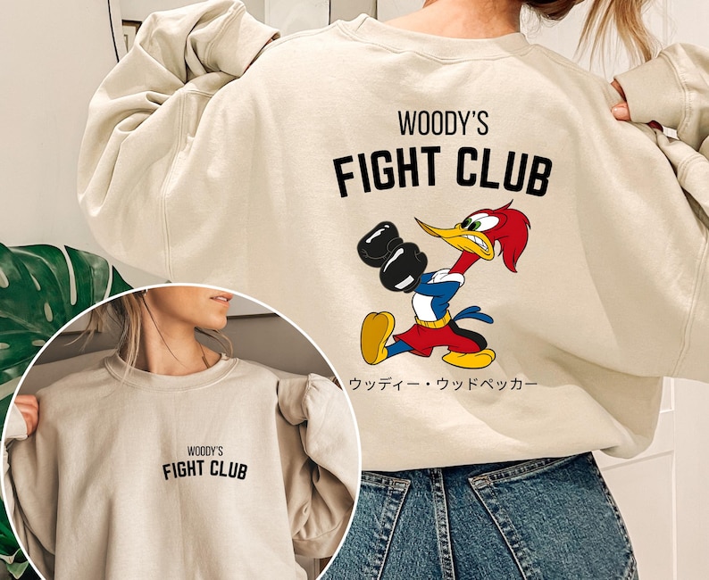 a woman wearing a sweatshirt that says woody's fight club