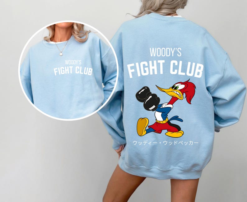 a woman wearing a sweatshirt with a cartoon character on it