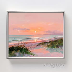 Może przedstawiać: Oprawiony obraz przedstawiający scenę na plaży o zachodzie słońca. Dzieło przedstawia żywe niebo w odcieniach różu i pomarańczy, spokojne morze i trawiaste wydmy. Tekst "MELISA'S DREAM Digital Prints" znajduje się w prawym dolnym rogu.