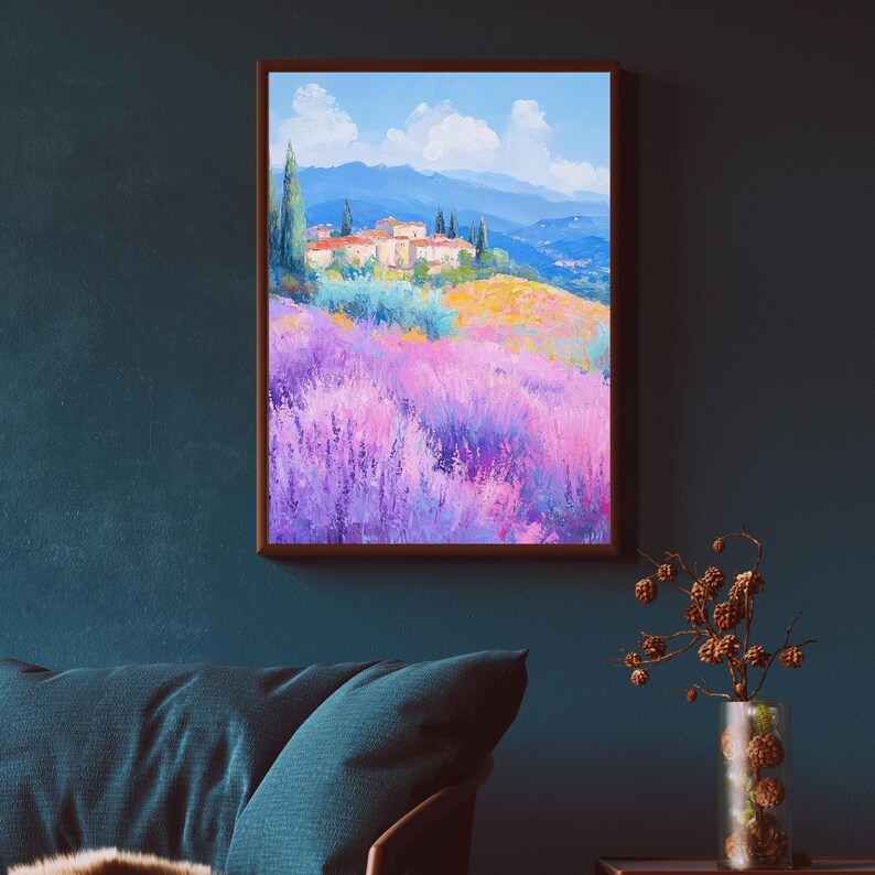 May include: A painting of a landscape with a small village in the distance. The village is surrounded by a field of purple flowers. The sky is blue with white clouds. The painting is framed in a brown frame.
