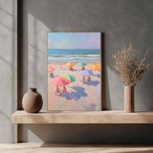May include: A painting of a beach scene with colorful umbrellas and people relaxing on the sand. The ocean is in the background and the sky is blue.