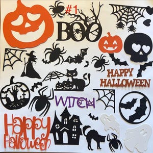 May include: A collection of Halloween-themed paper cutouts including a large orange pumpkin, black spiders, bats, a witch, a haunted house, ghosts, and text elements reading BOO, WITCH, and HAPPY HALLOWEEN in orange, black, and purple glitter finishes.