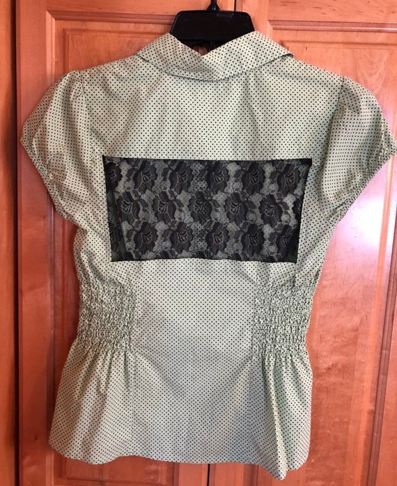 green and black polka dot blouse