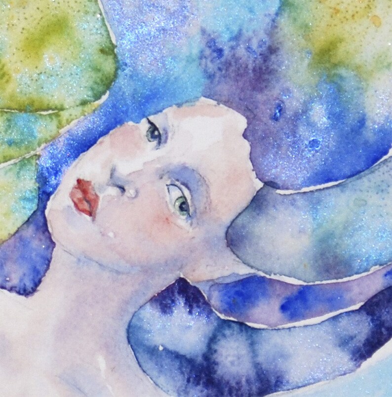 May include: A watercolor painting of a woman's face with blue and purple hair. The woman's eyes are closed and her lips are slightly parted. The background is a soft blue and green.
