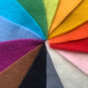 May include: A rainbow of felt fabric swatches arranged in a circular pattern. The colors are: blue, light blue, purple, brown, black, gray, white, pink, red, orange, yellow, green, and lime green.