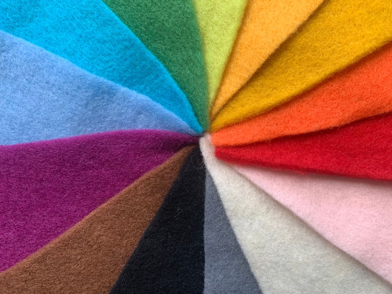 May include: A rainbow of felt fabric swatches arranged in a circular pattern. The colors are: blue, light blue, purple, brown, black, gray, white, pink, red, orange, yellow, green, and lime green.